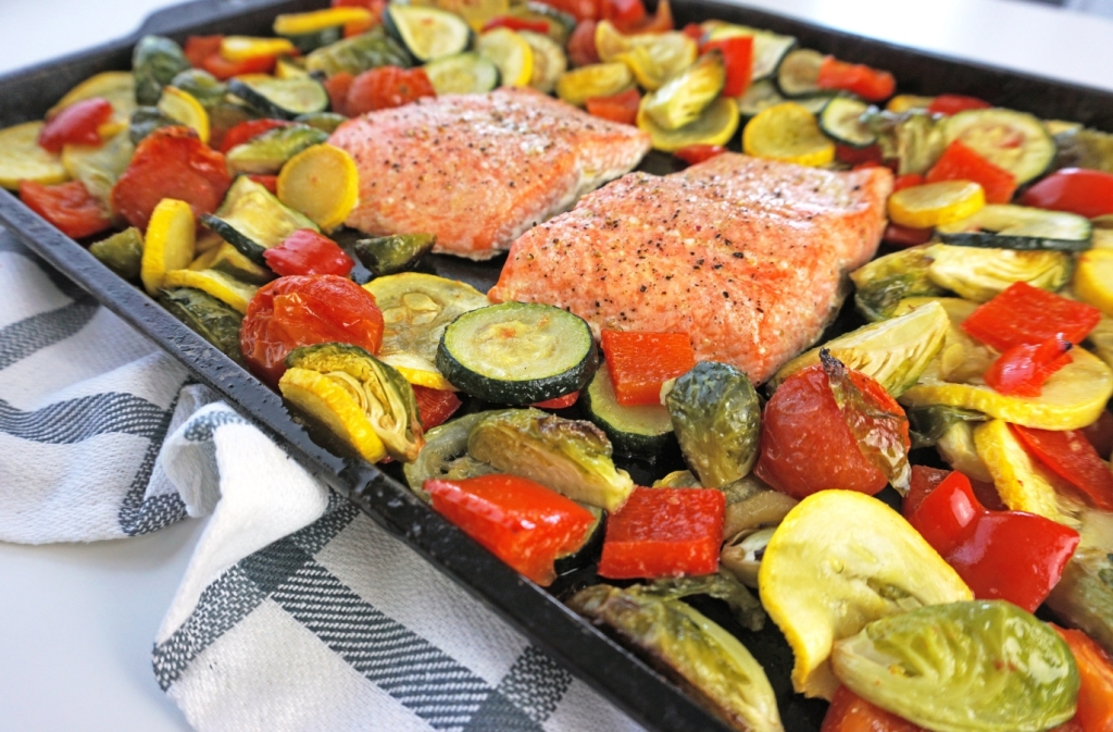 salmon sheet pan dinner on a blue and white checkered dish towel