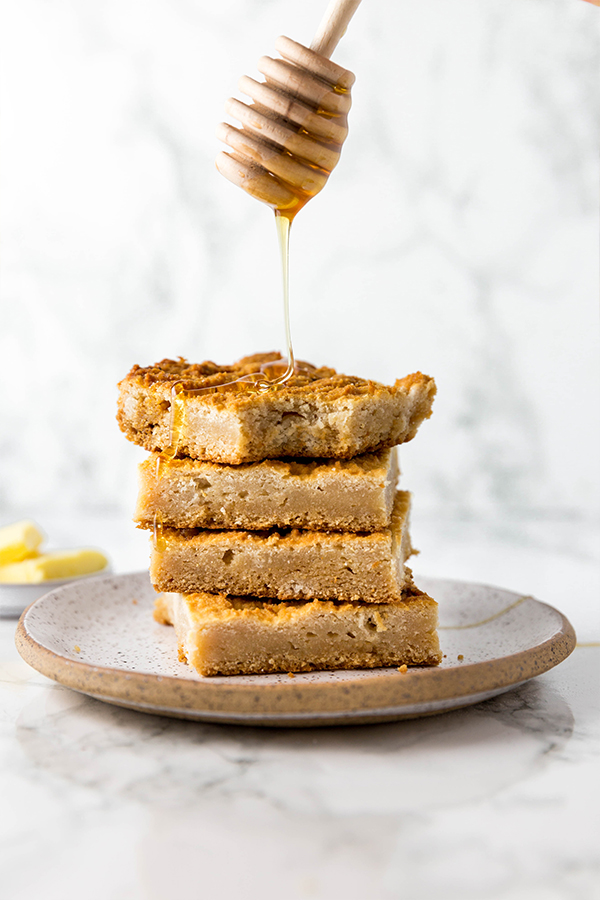 stack of grain free cornbread with honey being drizzled on top